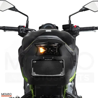 KAWASAKI Z900 turn signals feature bright yellow triangular designs that blink to alert others to your movements